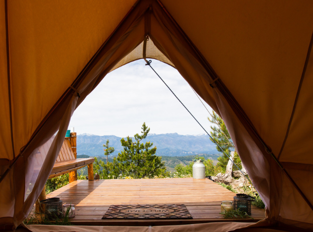 View from inside a luxury Stout Bell Tent overlooking the Blue Ridge Mountains with a professional wood platform.