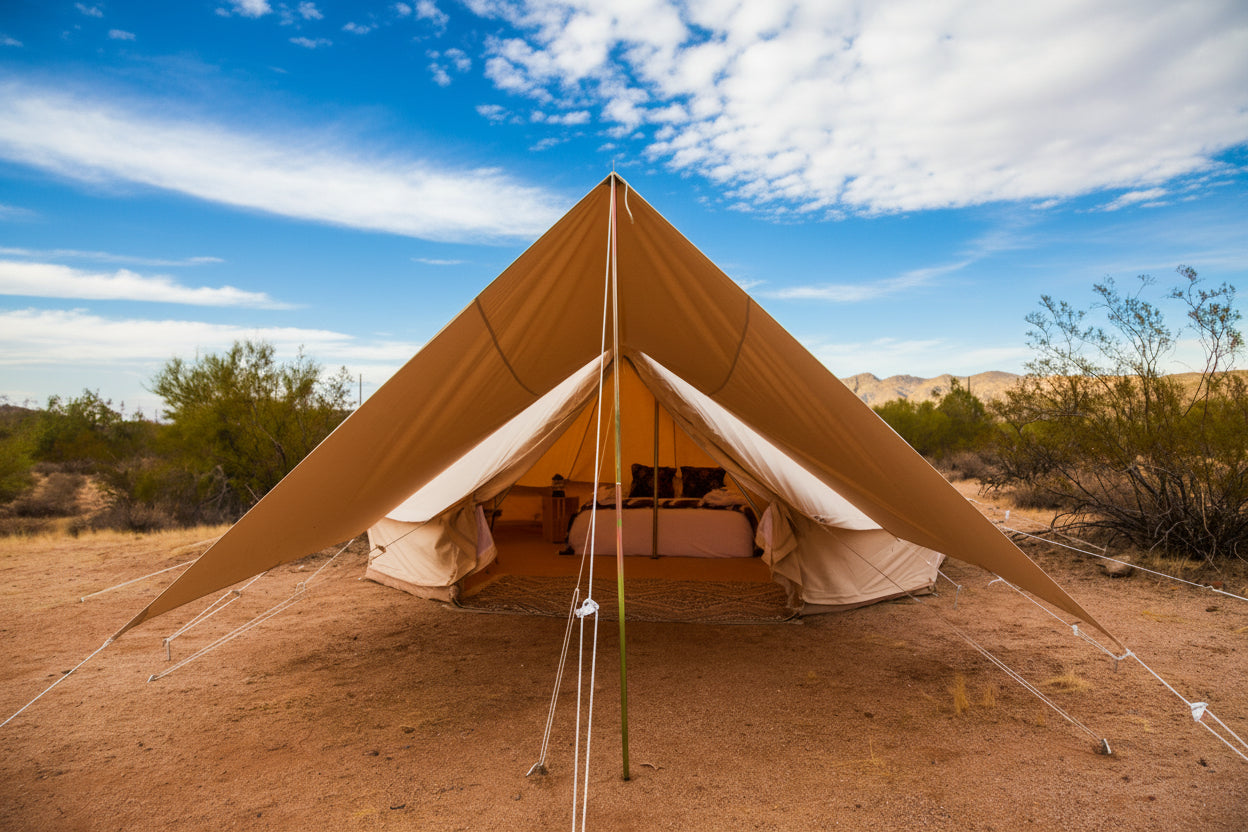 Beige bell tent in a desert landscape with a clear sky