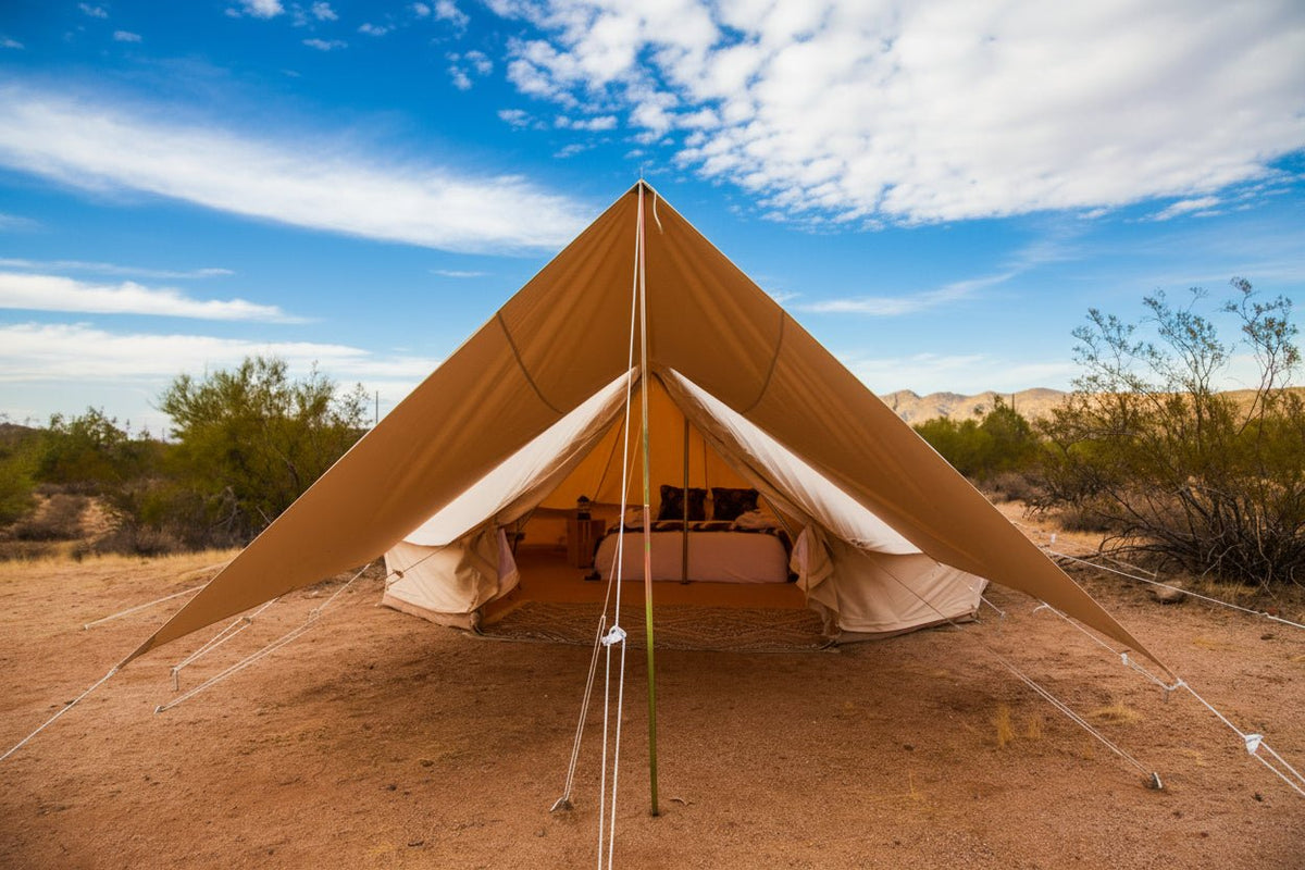 Beige bell tent in a desert landscape with a clear sky