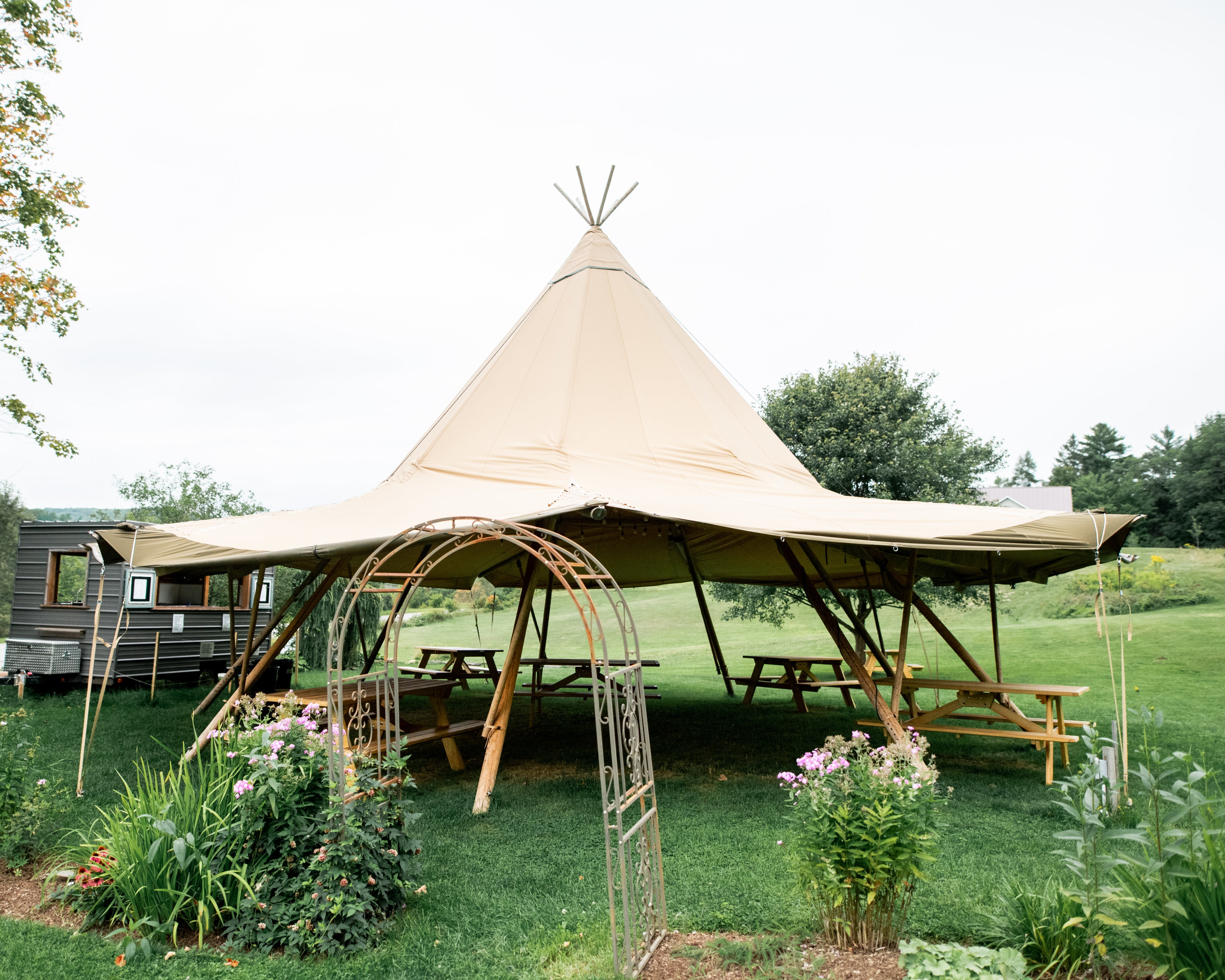 Durango tent with outdoor furniture and garden in a natural setting
