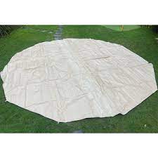 Beige tent footprint on grass.