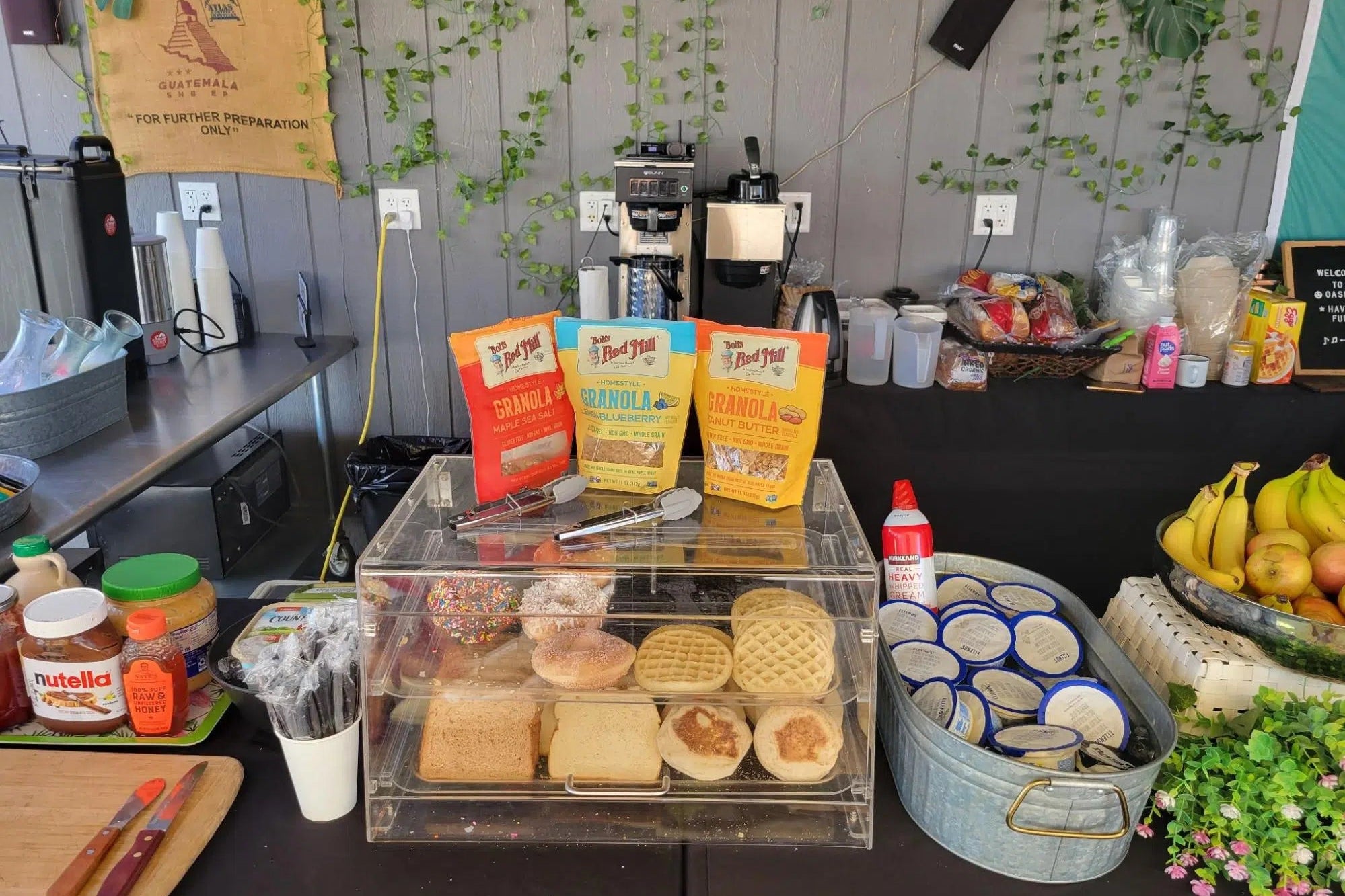 Snack bar setup with various food items and packaging on a counter.
