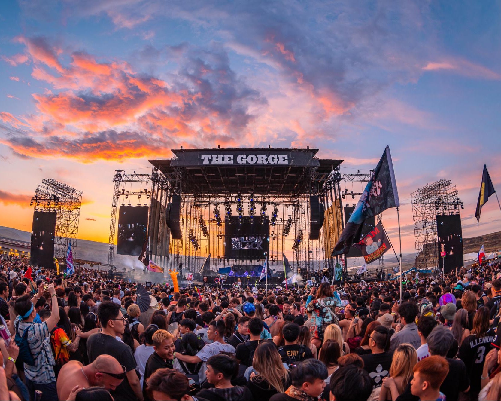 Large outdoor concert venue with 'The Gorge' branding under a colorful sunset sky.