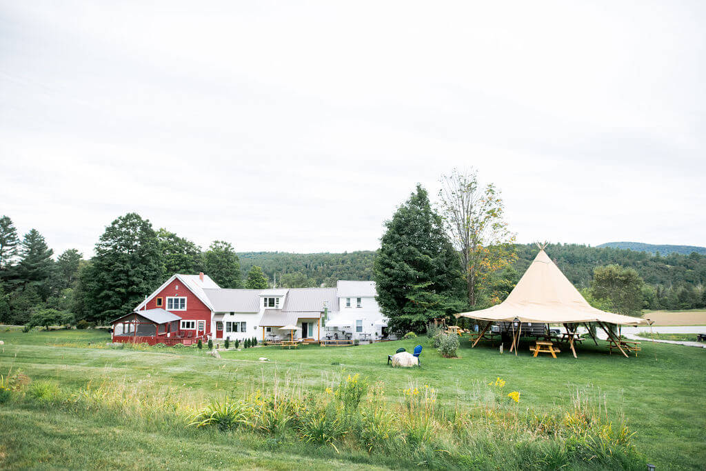 Luxury Stout Bell Tent set up in a lush vineyard for a Midwest farm stay glamping experience.