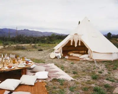 Stout Bell Tent styled as a backyard reading sanctuary with an outdoor table set