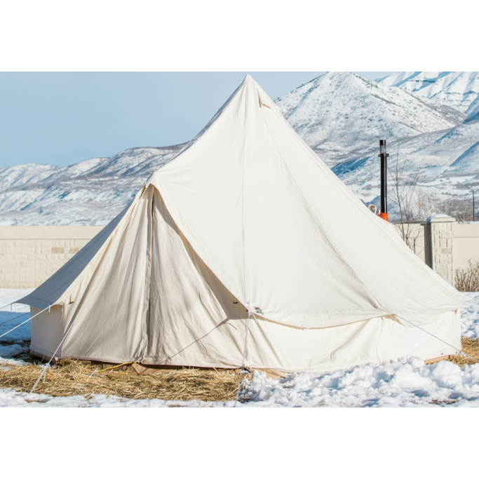 White tent with snow-capped mountains in the background