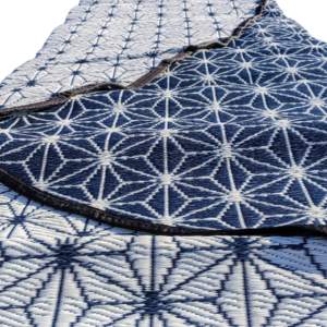 Close-up of a blue and white geometric half moon rug