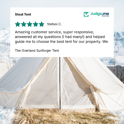A beige canvas bell tent pitched outdoors in snowy terrain with a bed of straw in the foreground. A large white review card overlays the top portion, showing a 5-star rating and text from Stefani C.