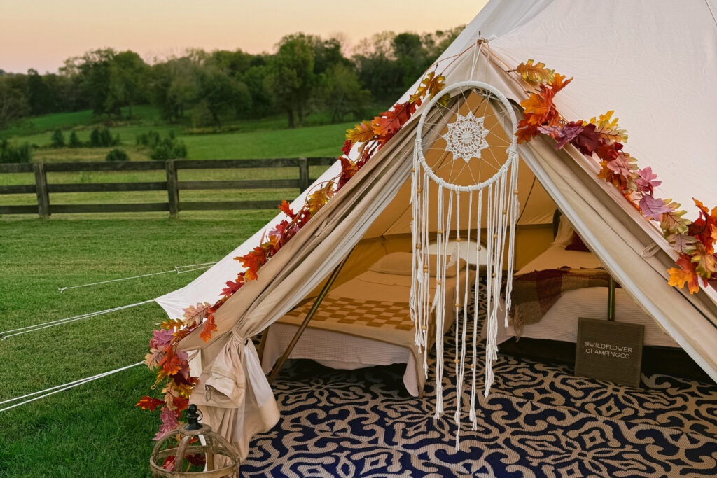 Luxury Stout Bell Tent set up in a lush vineyard for a Midwest farm stay glamping experience.