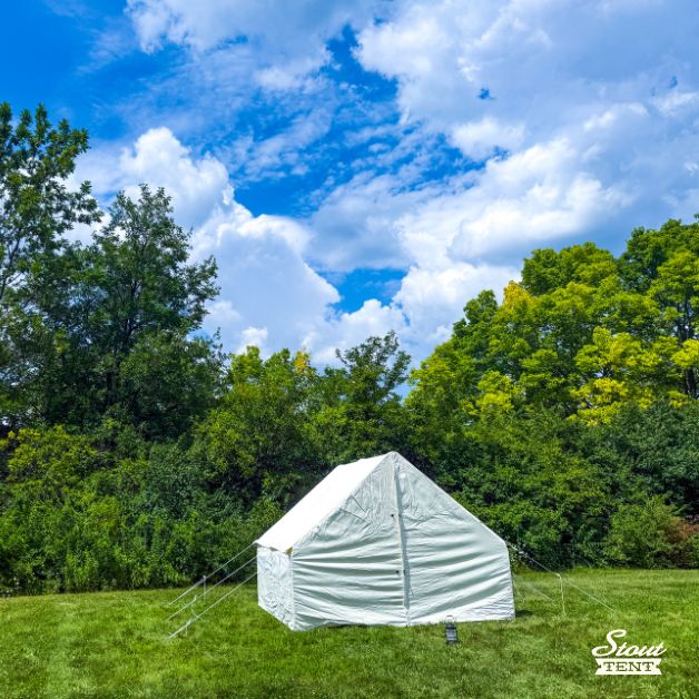 White canvas wall tent with doors closed, showing full exterior view.